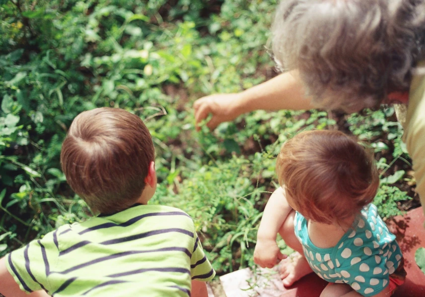 Grandmother and young children in the garden